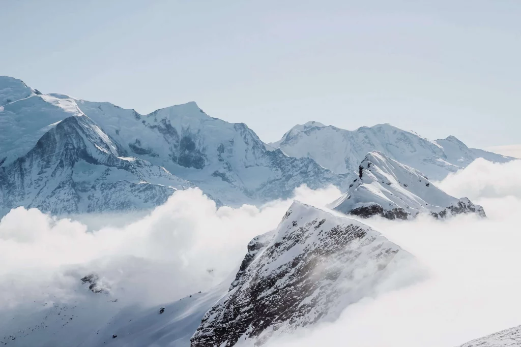 Snow-covered mountain peaks and clouds above the Alps on the Geneva to Flaine Transfer route