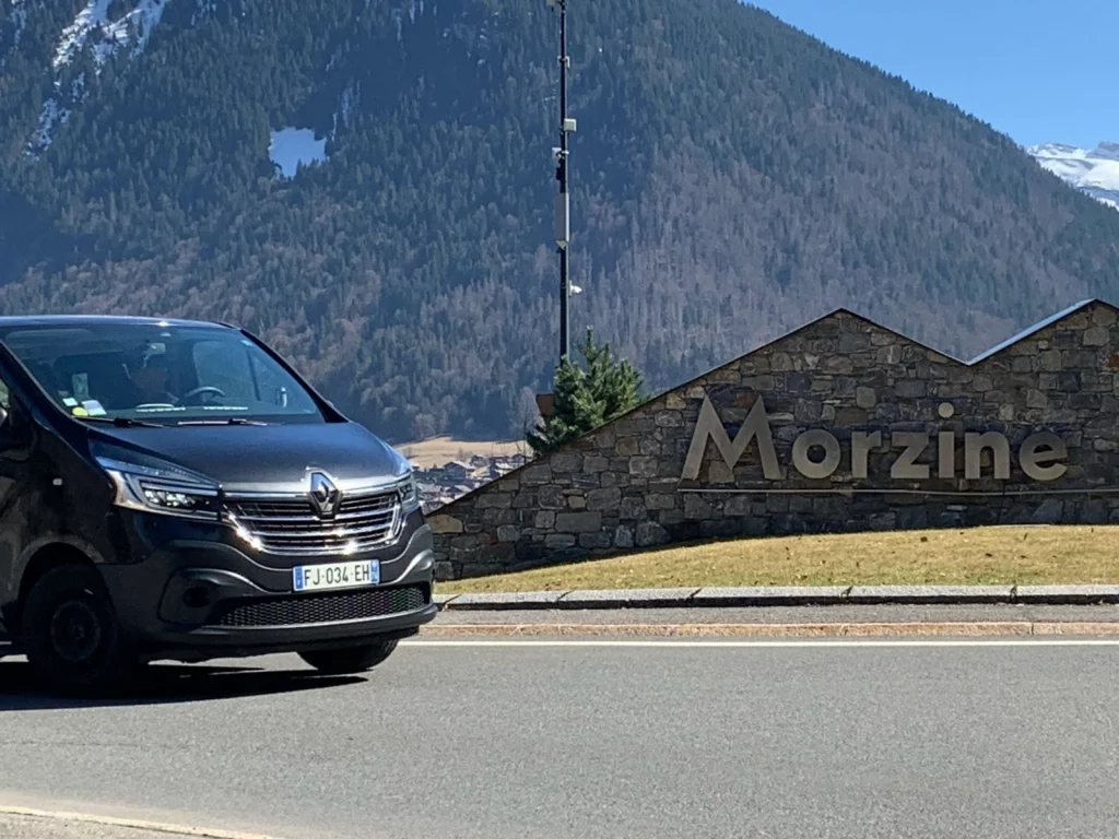 Summit Transfers van beside the Morzine sign for private transfers from Geneva to Morzine